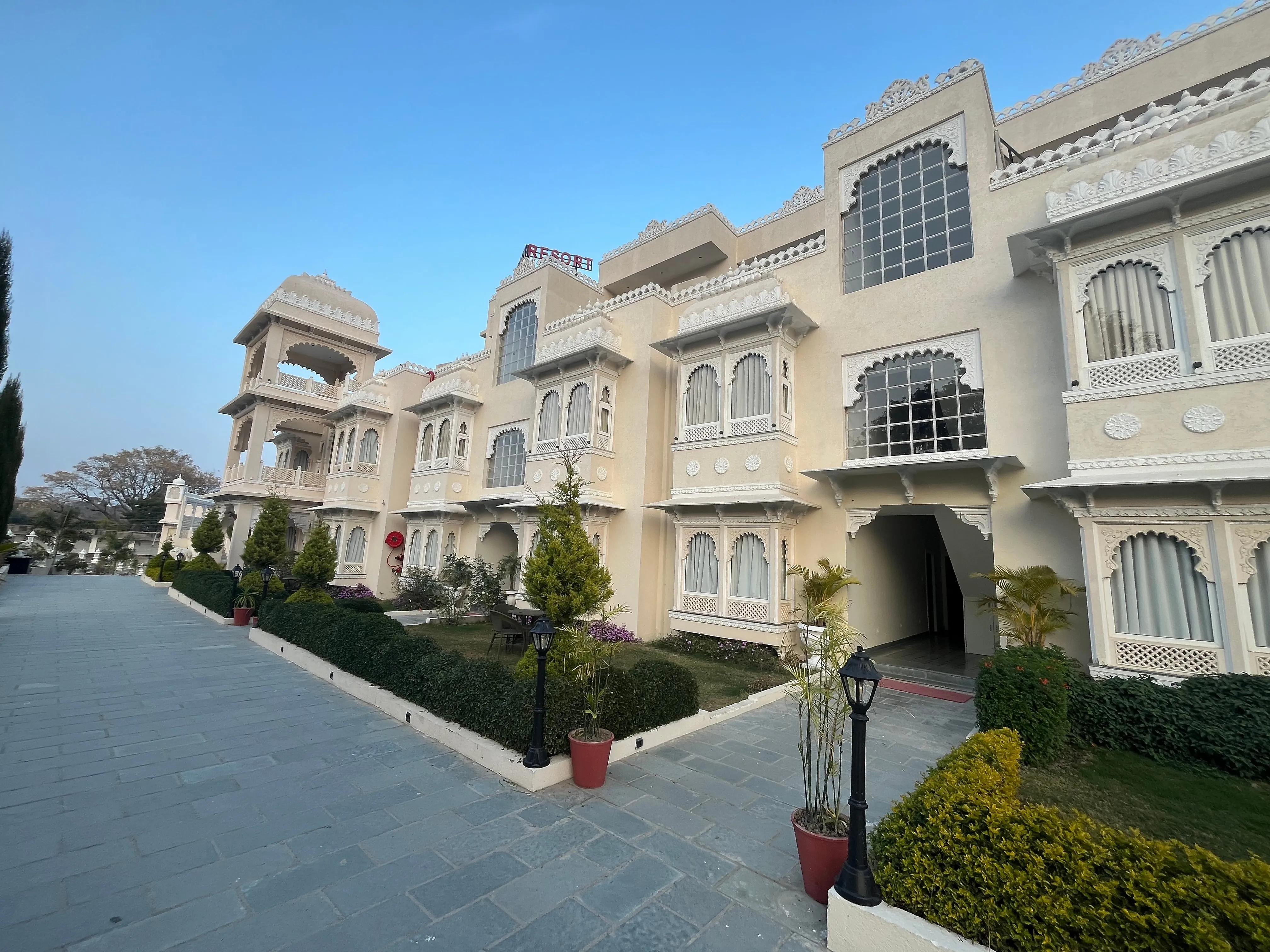 A modern living room with a brown leather sofa and wall art.